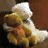 A 48x48 pixel animated contact sheet showing two frames of a buddy icon: left frame features a cartoonish yellow and white object resembling a seashell or abstract shape, right frame displays green text on dark background reading "Original Icons .com".