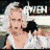 Pixelated image of two people in close embrace, one with light hair and the other dark hair, against a blurred background.