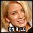 Pixelated close-up of a smiling person with blonde hair, wearing white earrings and dark clothing, with text 'I'M A LO' at the bottom.