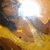 Animated sequence showing a bright light source moving across a yellow and brown textured surface with a small dark spot.