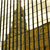 A pixelated static image shows vertical dark brown and black stripes against a light beige background with golden-brown shapes below.