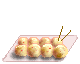 Four show a of eight round food items on a light pink tray with two brown sticks, one features an octopus-like character