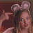 repeated pixelated images showing a person with light brown hair wearing pink bunny ears, pointing at the camera against a dark red background
