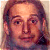 A 50x50 pixel animated contact sheet showing four frames of a celebrity mugshot-style icon with green text overlays on a gray background.