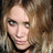 A four- shows a person with light brown wavy hair and blue eyes in different poses against a dark background