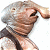 Pixelated image of a person with light brown hair wearing a dark sleeveless top, holding a light-colored object near their face.