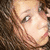 Pixelated portrait of a person with brown hair on left, blue text "Kaila Mae Mashaw" on pink background split into four quadrants.