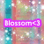Pixelated icon with pastel background and purple text reading 'Blossom<3' over blurred floral and teal vertical stripes.