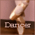 Pixelated image of a ballet dancer's foot in pointe shoe against pink and brown background with 'Dancer' text overlay.