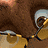 A pixelated close-up of a brown-furred character with large eyes and purple-accented ears, partially cropped on the right side.