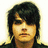 Pixelated portrait of a person with dark hair and a neutral expression, next to pink text on a dark background.