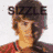 Pixelated image of a person with brown hair and red clothing, featuring text "SIZZLE" above the head and a pink heart symbol.