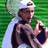 Pixelated static image of a tennis player holding a racket and trophy on green background.