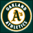 Circular icon with dark teal background, gold border, and central white circle containing stylized 'A's in brown and yellow.