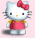 Hello Kitty character with red bow, pink dress, and yellow accents on a light pink background.