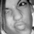 Monochrome pixelated image of a person's face with visible eye, nose, and mouth details in grayscale tones.