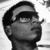 Pixelated grayscale image of a person's head and neck in profile, facing right with eyes closed and mouth slightly open.