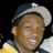 A person wearing a dark blue and gray baseball cap with a white star on the front, yellow and dark blue clothing, smiling in a of four