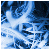 Pixelated blue and white abstract pattern with varying shades of cyan, navy, and light gray forming irregular cloud-like shapes against a dark background.