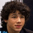 A pixelated image of a person with curly brown hair and a dark jacket, with blue text reading "he is my husband" and "so back off!" on black backgrounds.
