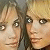 A pixelated image of four people with blonde hair, showing slight variations in facial expressions and head positions