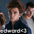 Pixelated image of two people with brown hair, one in dark clothing, the other in light clothing, with text at the bottom.