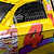Yellow race car with red number 4, purple stripe, and sponsor logos on side; animated sequence shows motion blur effects.