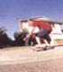 A person in a red shirt and dark shorts performs a skateboarding trick across six showing motion from left to right