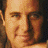 A 48x48 pixel buddy icon featuring a contact sheet layout with four quadrants: top-left shows a partial portrait of a person, top-right displays text "VINCE GILL" on striped background, bottom-left contains a stylized monogram logo, and bottom-right is empty gray space.