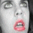 A pixelated image shows a pale face with closed eyes and open mouth on the left, next to red text reading "Zombie Love" and three pink hearts above a white heart on black background.