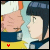 Animated sequence of two anime-style characters in profile view, with red heart symbols appearing and moving across their faces against a light blue background.
