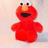 Red puppet-like character with large eyes and open mouth on light background, next to black with red pixelated text