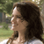 Pixelated static image of a woman's profile with long dark hair against an outdoor background, rendered in low resolution typical of early 2000s buddy icons.