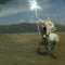Animated sequence of a rider on a horse galloping across a grassy plain under a bright sun, with background mountains and changing light effects.