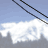 Animated sequence showing three figures on a ski lift ascending against a cloudy sky, with one figure raising arms in blue clothing.