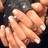 Pixelated close-up of multiple hands clasped together against a dark background with light-colored fingertips.