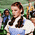 A 2x2 contact sheet of a 50x50 animated buddy icon featuring Dorothy from The Wizard of Oz in two distinct poses with red shoes and blue dress, displayed on a gray background.