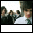 Animated contact sheet of a 5x5 grid showing sequential frames from an AIM buddy icon animation featuring a person in a white shirt and green tie with dark hair, surrounded by blurred background figures, with text progressively forming "PANIC! AT THE DISCO" across the bottom row.