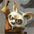 A pixelated cartoon animal with large ears, brown and white fur, and a small black nose, holding a yellow object against a gray background.