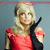 A woman with blonde hair in a red dress and black glove poses against a gray background, her head slightly tilted.