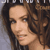 Static pixelated image of a person with long brown hair and light skin tone, cropped to show upper face and shoulders against gray background.