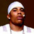 Static pixelated image of a person wearing a white headwrap and white shirt against dark background with visible dithering and color blending artifacts.
