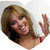 A heart-shaped icon shows a woman with shoulder-length brown hair smiling and waving in one view, then wearing a bikini top in another view.