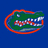 Green alligator head with white teeth and red accents on a blue background, outlined in red.