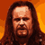 Pixelated static image of a person with long dark hair and beard against an orange gradient background, rendered in low-resolution 8-bit style.