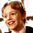 Pixelated static image of a person with light brown hair and fair skin, wearing dark clothing against a white background.