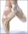 Pixelated static image of a person's lower body in ballet pose with legs extended against white background.