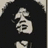 Pixelated image of a person with long dark hair and a white shirt, next to blue text reading 'slash' and 'rocks' on a black background.