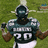 A pixelated image of a football player in a green and white uniform holding a microphone, with text elements on adjacent