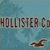 Pixelated image with blue background, partial text reading 'HOLLISTER Co', and a brown bird-like shape in the lower right.